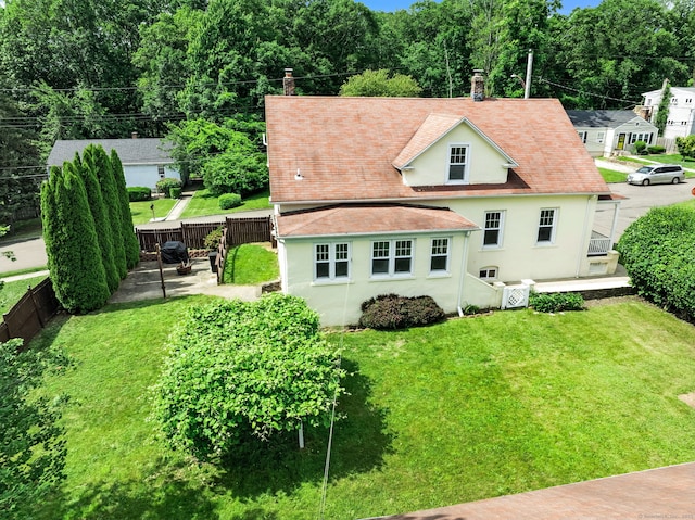 92 Yates St, West Haven, CT 06516 - back of house featuring a chimney, stucco siding, a fenced backyard, and a patio area