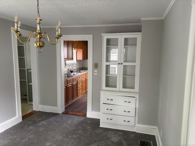 97 Capen St, Windsor, CT 06095 - dining room featuring a chandelier, a textured ceiling, dark carpet, and ornamental molding