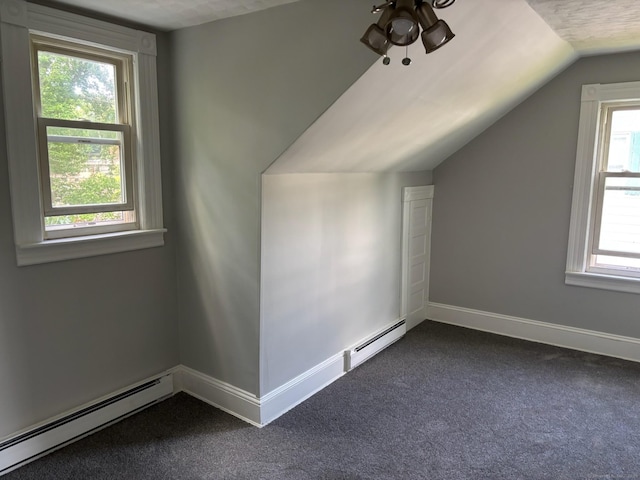 97 Capen St, Windsor, CT 06095 - bonus room featuring a baseboard heating unit, vaulted ceiling, plenty of natural light, and dark colored carpet