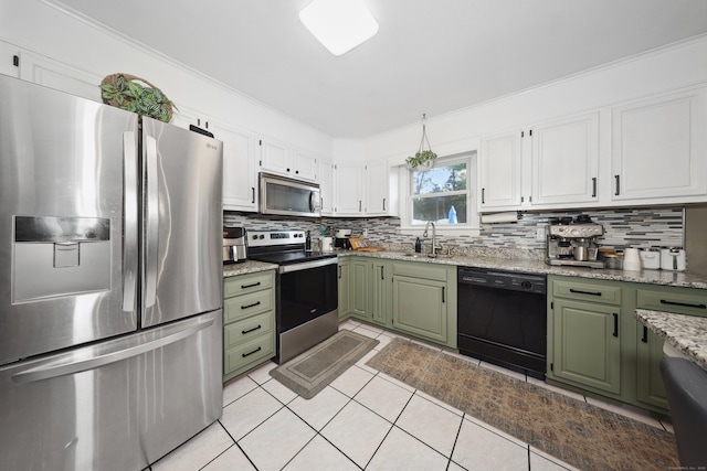 69 Sills Dr, Watertown, CT 06779 - kitchen with stainless steel appliances, green cabinetry, decorative backsplash, light tile patterned floors, and crown molding