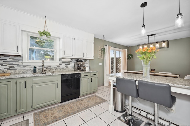 69 Sills Dr, Watertown, CT 06779 - kitchen with dishwasher, a kitchen breakfast bar, backsplash, hanging light fixtures, and light stone countertops