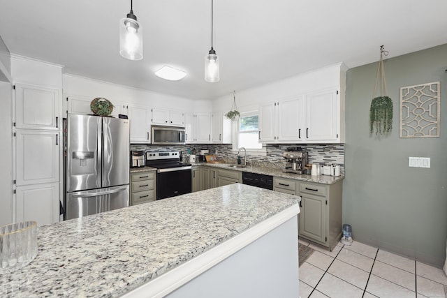 69 Sills Dr, Watertown, CT 06779 - kitchen featuring appliances with stainless steel finishes, tasteful backsplash, decorative light fixtures, and light tile patterned floors
