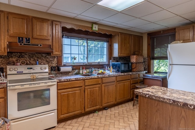 47 Ridge Rd, Middletown, CT 06457 - kitchen with white appliances, under cabinet range hood, healthy amount of natural light, backsplash, and a drop ceiling