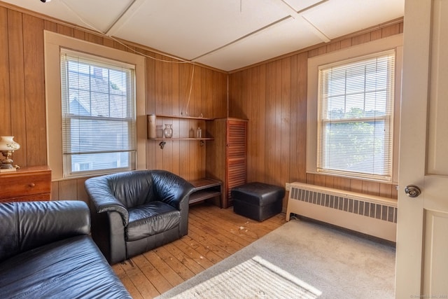 47 Ridge Rd, Middletown, CT 06457 - sitting room featuring radiator heating unit, healthy amount of natural light, wooden walls, and light wood finished floors