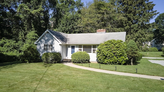 19 Eli Chapman Rd, East Haddam, CT 06469 - view of front of house with a front lawn, a chimney, and a shingled roof