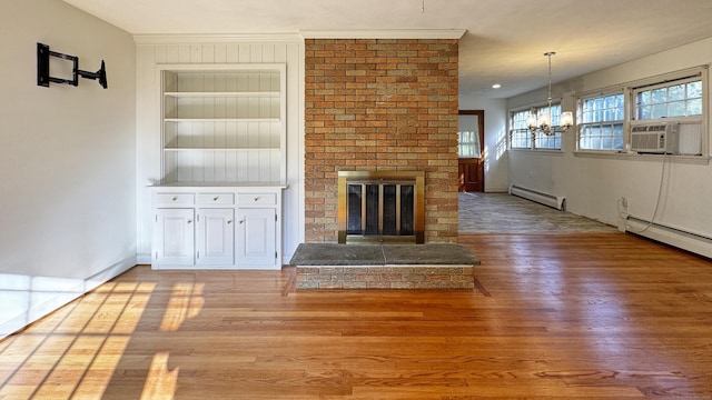 19 Eli Chapman Rd, East Haddam, CT 06469 - unfurnished living room with baseboard heating, cooling unit, a chandelier, a fireplace, and wood finished floors