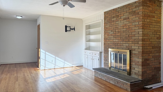 19 Eli Chapman Rd, East Haddam, CT 06469 - unfurnished living room featuring built in features, a ceiling fan, a brick fireplace, and wood finished floors
