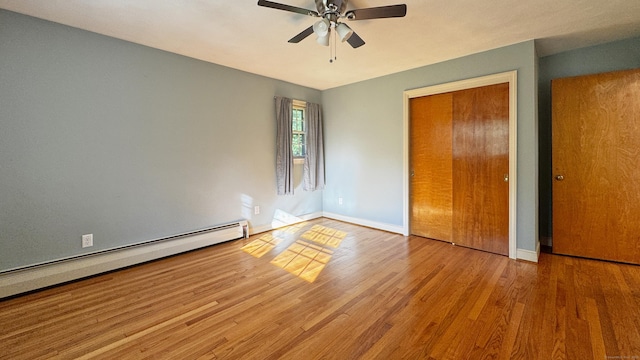 19 Eli Chapman Rd, East Haddam, CT 06469 - unfurnished bedroom featuring a baseboard heating unit, wood finished floors, a closet, and ceiling fan