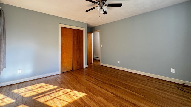 19 Eli Chapman Rd, East Haddam, CT 06469 - unfurnished bedroom featuring a baseboard heating unit, wood finished floors, a closet, and ceiling fan