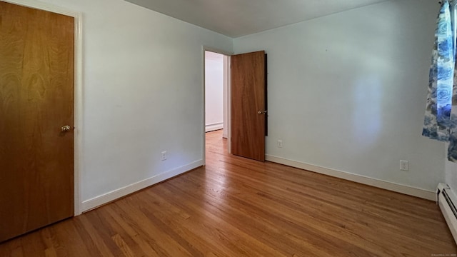 19 Eli Chapman Rd, East Haddam, CT 06469 - unfurnished bedroom with wood finished floors and a baseboard heating unit