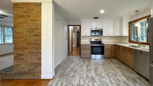 19 Eli Chapman Rd, East Haddam, CT 06469 - kitchen with stainless steel appliances, healthy amount of natural light, light countertops, decorative light fixtures, and brick wall