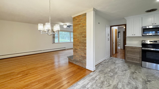 19 Eli Chapman Rd, East Haddam, CT 06469 - kitchen with appliances with stainless steel finishes, baseboard heating, a chandelier, white cabinetry, and light wood-style floors