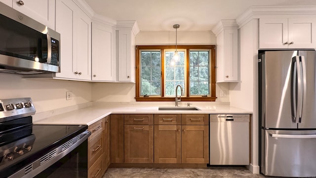 19 Eli Chapman Rd, East Haddam, CT 06469 - kitchen with stainless steel appliances, white cabinets, light countertops, decorative light fixtures, and brown cabinetry