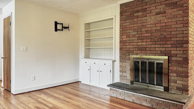 19 Eli Chapman Rd, East Haddam, CT 06469 - unfurnished living room with a fireplace, built in shelves, and light wood-style flooring
