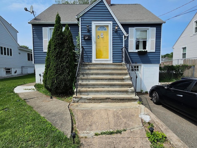 27 White Rose Ave, Waterbury, CT 06708 - view of front of house featuring a chimney, a shingled roof, and entry steps