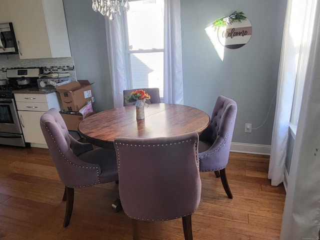 27 White Rose Ave, Waterbury, CT 06708 - dining room featuring light wood finished floors and a chandelier