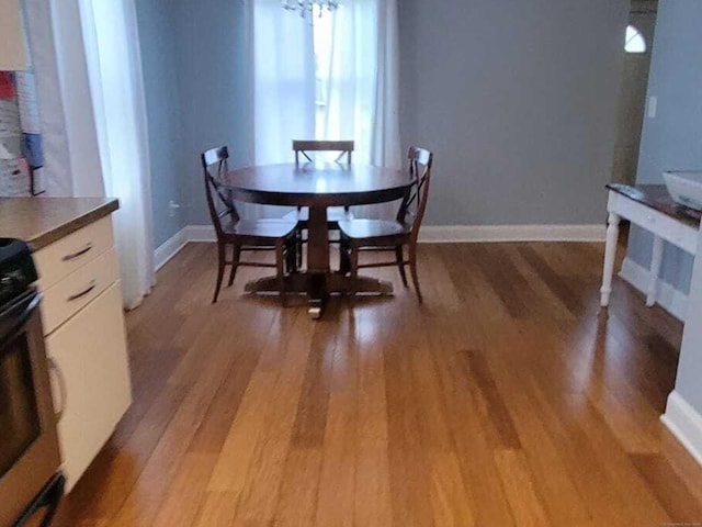 27 White Rose Ave, Waterbury, CT 06708 - dining room with light wood-type flooring and baseboards