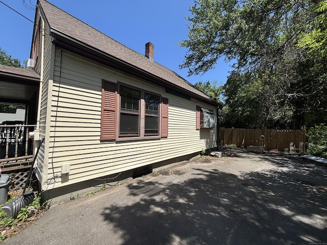 443 Todd Rd, Wolcott, CT 06716 - view of property exterior featuring a patio area, a shingled roof, and a chimney