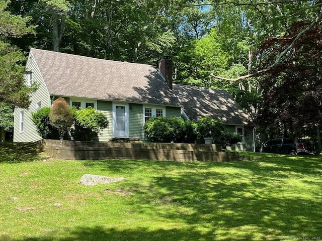 87 Mcveagh Rd, Westbrook, CT 06498 - view of front of house featuring a chimney, a front yard, and roof with shingles
