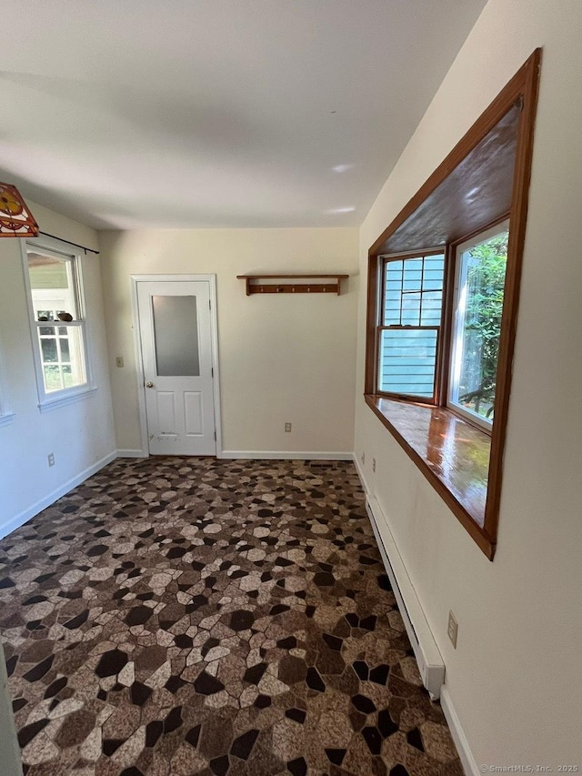 87 Mcveagh Rd, Westbrook, CT 06498 - empty room with plenty of natural light and a baseboard radiator