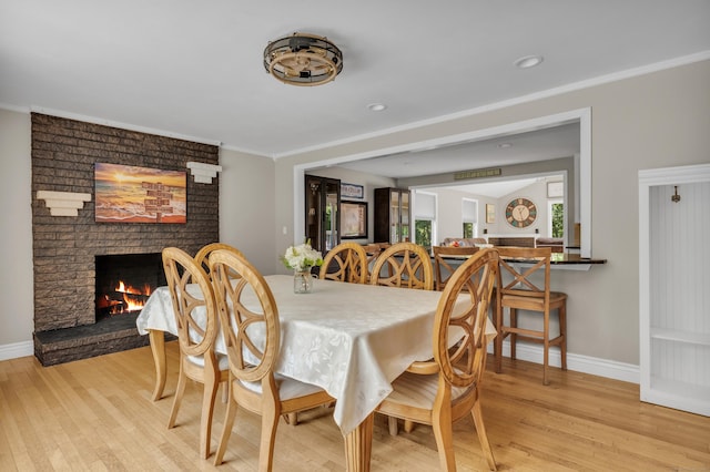 33 Woodside Rd, Guilford, CT 06437 - dining room featuring light wood-style floors, ornamental molding, a brick fireplace, and recessed lighting