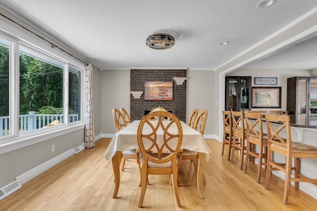 33 Woodside Rd, Guilford, CT 06437 - dining space featuring light wood-style floors, a fireplace, and ornamental molding