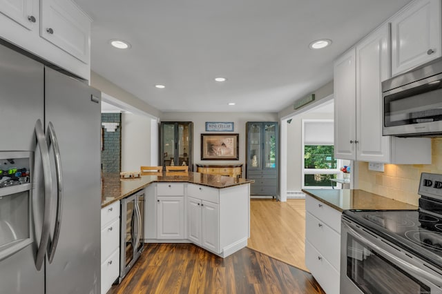 33 Woodside Rd, Guilford, CT 06437 - kitchen featuring appliances with stainless steel finishes, wine cooler, a peninsula, white cabinetry, and recessed lighting