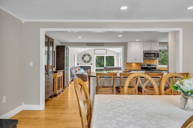 33 Woodside Rd, Guilford, CT 06437 - dining room with light wood-style flooring, crown molding, and recessed lighting