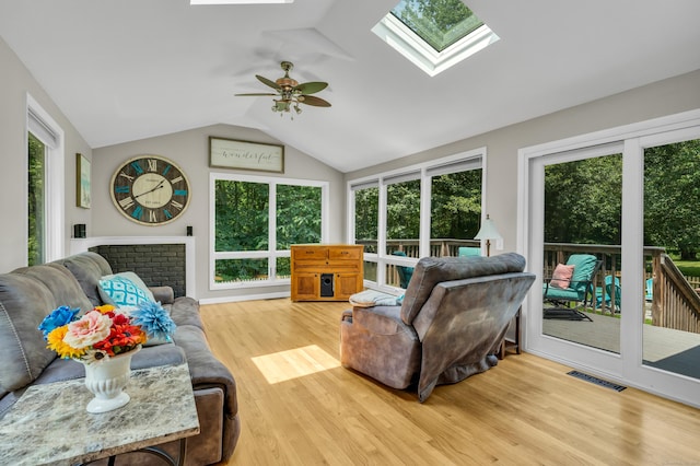 33 Woodside Rd, Guilford, CT 06437 - living room featuring a skylight, lofted ceiling, wood finished floors, and a ceiling fan