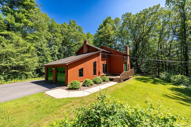 4 Coppergate Rd, East Granby, CT 06026 - view of home's exterior with a chimney, a lawn, a wooden deck, and a garage