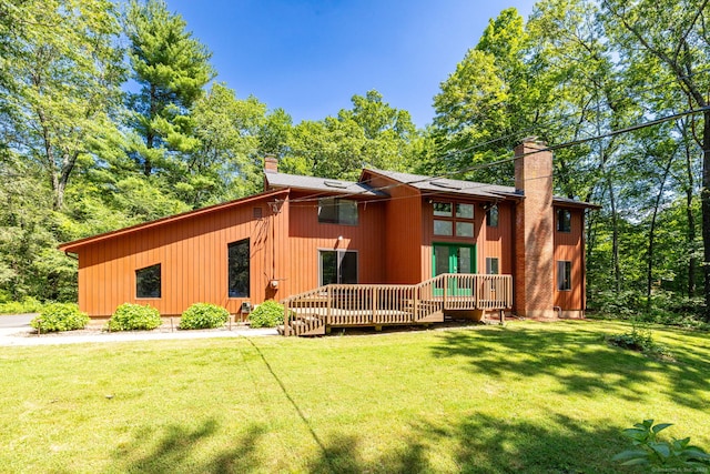 4 Coppergate Rd, East Granby, CT 06026 - back of house featuring a chimney, a deck, and a lawn