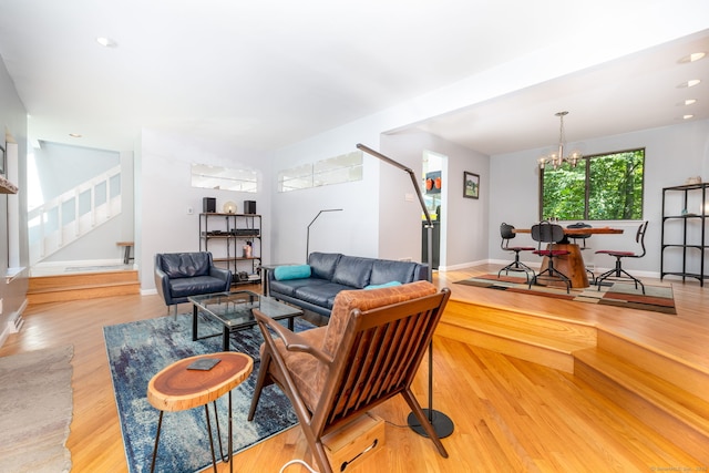 4 Coppergate Rd, East Granby, CT 06026 - living area with stairway, wood finished floors, and a chandelier