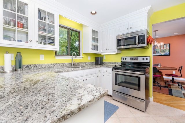 4 Coppergate Rd, East Granby, CT 06026 - kitchen featuring stainless steel appliances, white cabinets, a chandelier, light stone counters, and glass insert cabinets