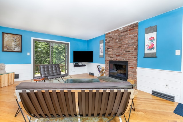 4 Coppergate Rd, East Granby, CT 06026 - living area with a wainscoted wall, wood finished floors, and a fireplace
