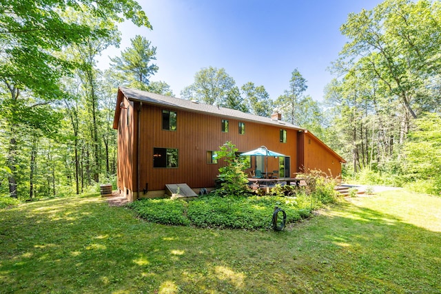 4 Coppergate Rd, East Granby, CT 06026 - view of property exterior featuring a yard, a deck, and a chimney