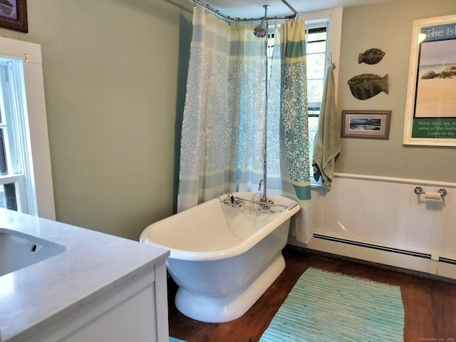 51 Moodus Leesville Rd, East Haddam, CT 06469 - bathroom featuring a baseboard radiator, a freestanding bath, vanity, wainscoting, and wood finished floors