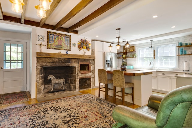 51 Moodus Leesville Rd, East Haddam, CT 06469 - living area with light wood-type flooring, recessed lighting, a fireplace, and beam ceiling