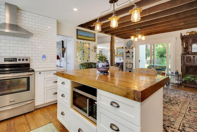 51 Moodus Leesville Rd, East Haddam, CT 06469 - kitchen with appliances with stainless steel finishes, wooden counters, wall chimney exhaust hood, tasteful backsplash, and beam ceiling