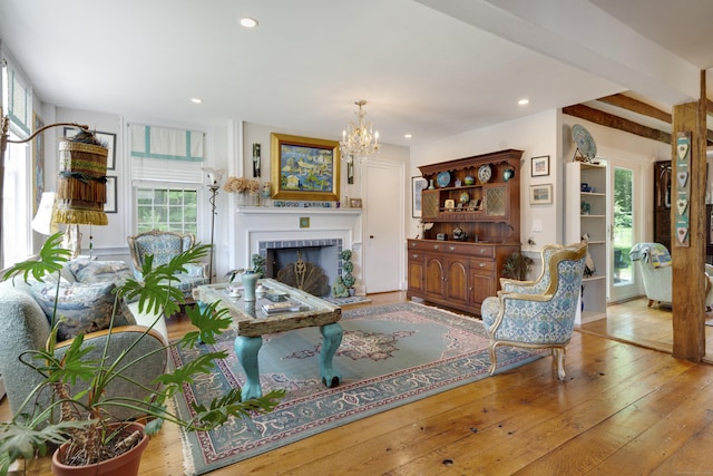 51 Moodus Leesville Rd, East Haddam, CT 06469 - living area featuring wood-type flooring, a fireplace with raised hearth, a chandelier, and recessed lighting