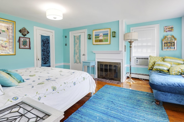 51 Moodus Leesville Rd, East Haddam, CT 06469 - bedroom featuring a baseboard radiator, wood finished floors, and cooling unit