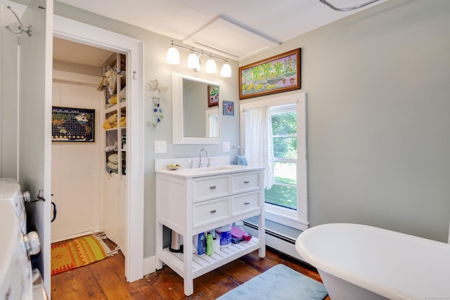 51 Moodus Leesville Rd, East Haddam, CT 06469 - full bath featuring wood finished floors, vanity, a soaking tub, and baseboard heating