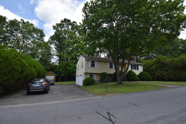 81 Birchwood Dr, Torrington, CT 06790 - view of front of property featuring driveway, a front yard, and a chimney