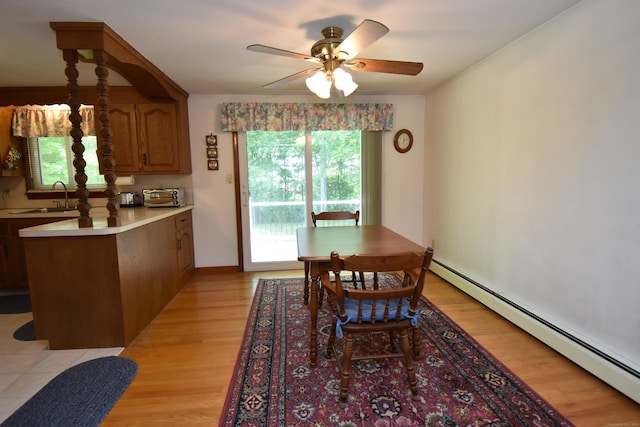 81 Birchwood Dr, Torrington, CT 06790 - dining space with a baseboard heating unit, a ceiling fan, and light wood-style floors