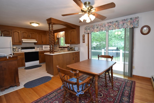 81 Birchwood Dr, Torrington, CT 06790 - kitchen with white appliances, under cabinet range hood, light countertops, and brown cabinets