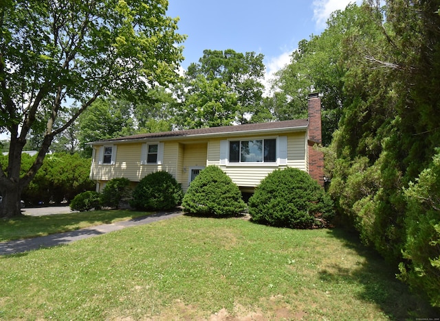 81 Birchwood Dr, Torrington, CT 06790 - raised ranch with a front yard and a chimney