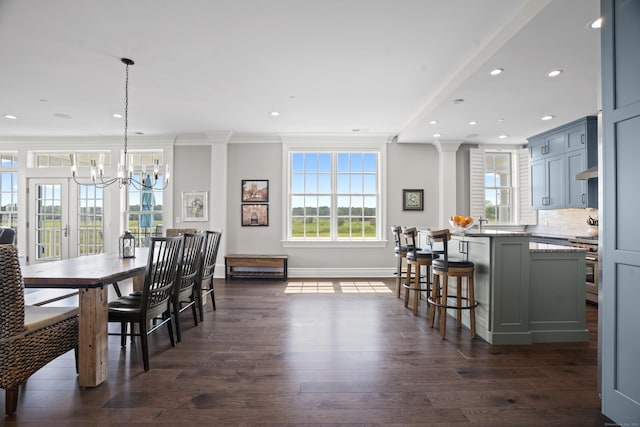 66 High St Unit 31, Guilford, CT 06437 - dining room featuring dark wood-type flooring, recessed lighting, a chandelier, ornamental molding, and decorative columns
