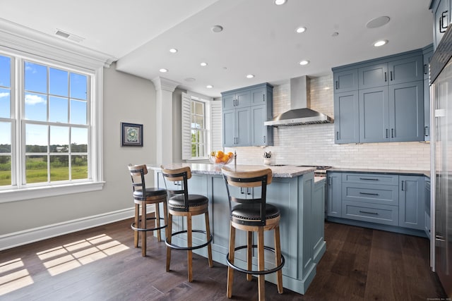 66 High St Unit 31, Guilford, CT 06437 - kitchen with wall chimney exhaust hood, backsplash, recessed lighting, a center island, and dark wood finished floors