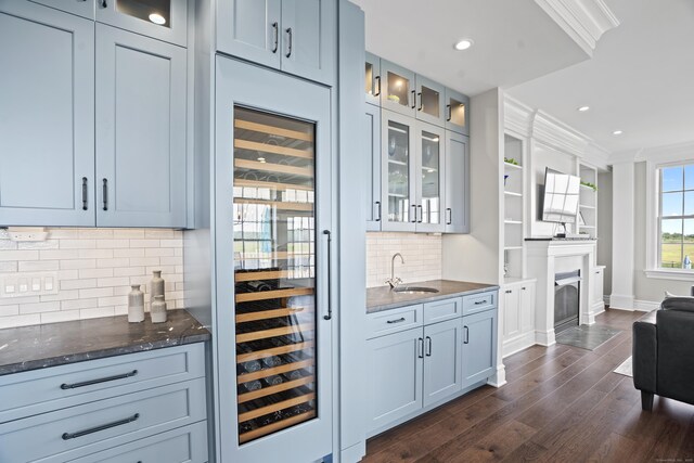 66 High St Unit 31, Guilford, CT 06437 - indoor wet bar featuring beverage cooler, dark wood-style floors, recessed lighting, backsplash, and a fireplace