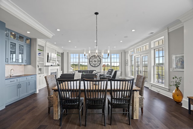 66 High St Unit 31, Guilford, CT 06437 - dining area with crown molding, dark wood finished floors, a chandelier, recessed lighting, and a fireplace