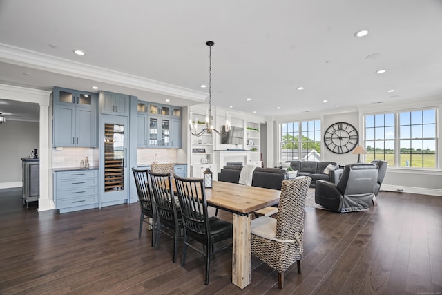 66 High St Unit 31, Guilford, CT 06437 - dining space featuring crown molding, recessed lighting, dark wood finished floors, wine cooler, and a fireplace